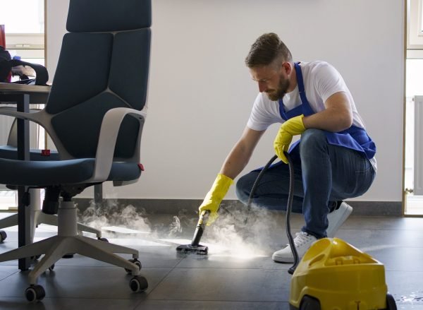 professional-cleaning-service-person-using-steam-cleaner-office